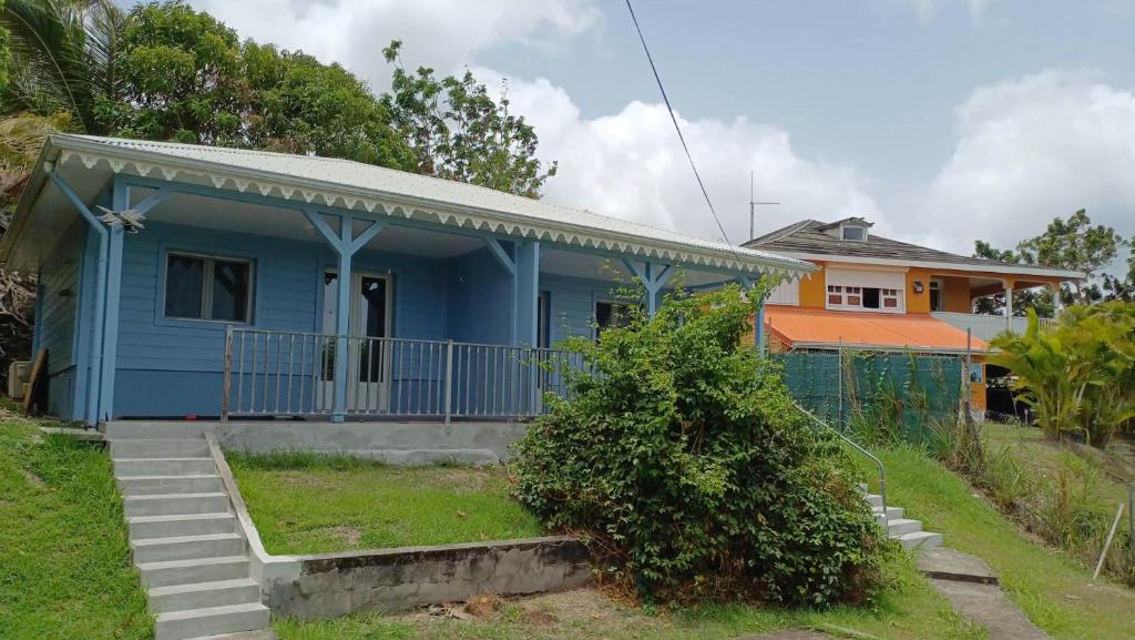 a blue house with a fence in front of it at Maya Dream in Morne Blanc