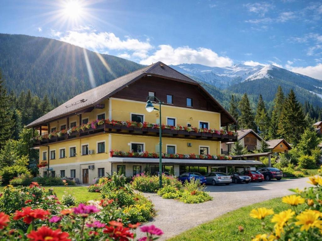 a large building with cars parked in a parking lot at Bösenstein in Hohentauern
