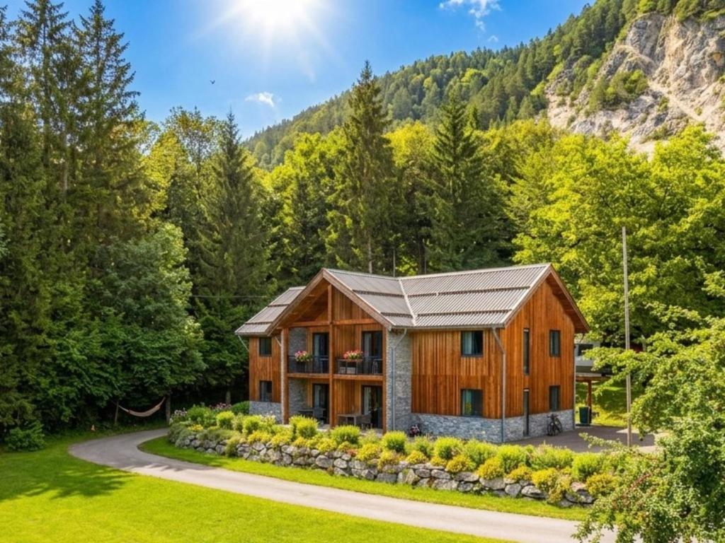 a home in the woods with a mountain at SeeZeit am Pressegger See in Lake Pressegg