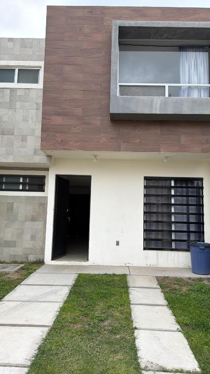 a house with a garage and a door at Casa spello in Gómez
