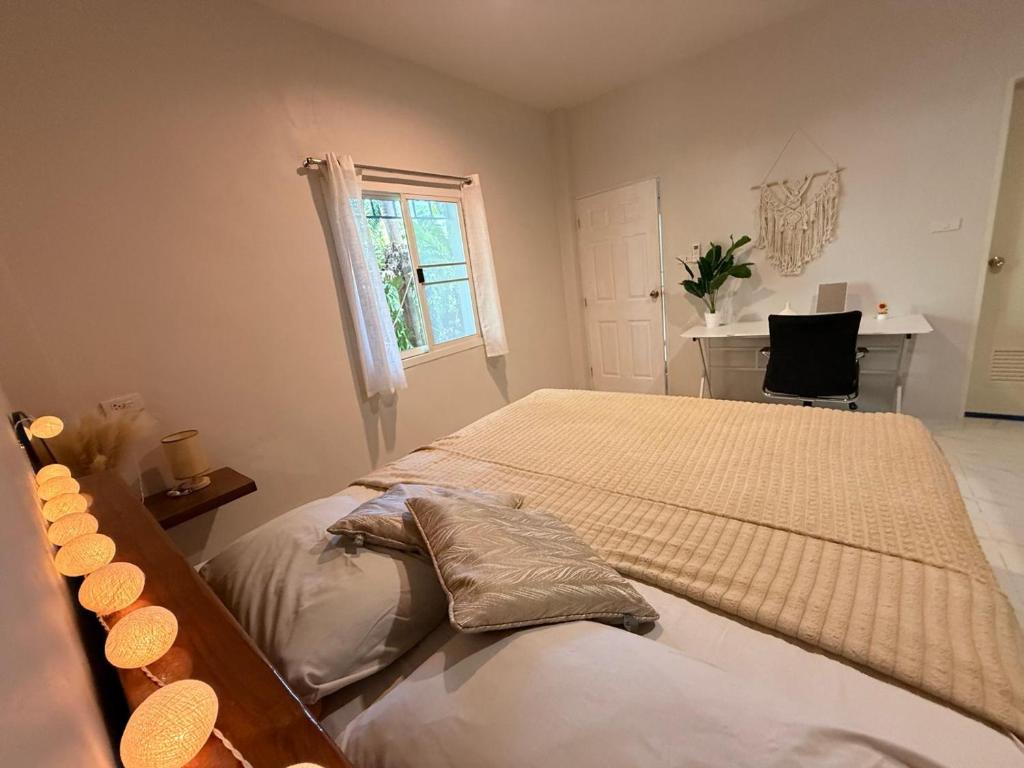 a bedroom with two beds and a desk and a window at Diamond House in Srithanu in Srithanu