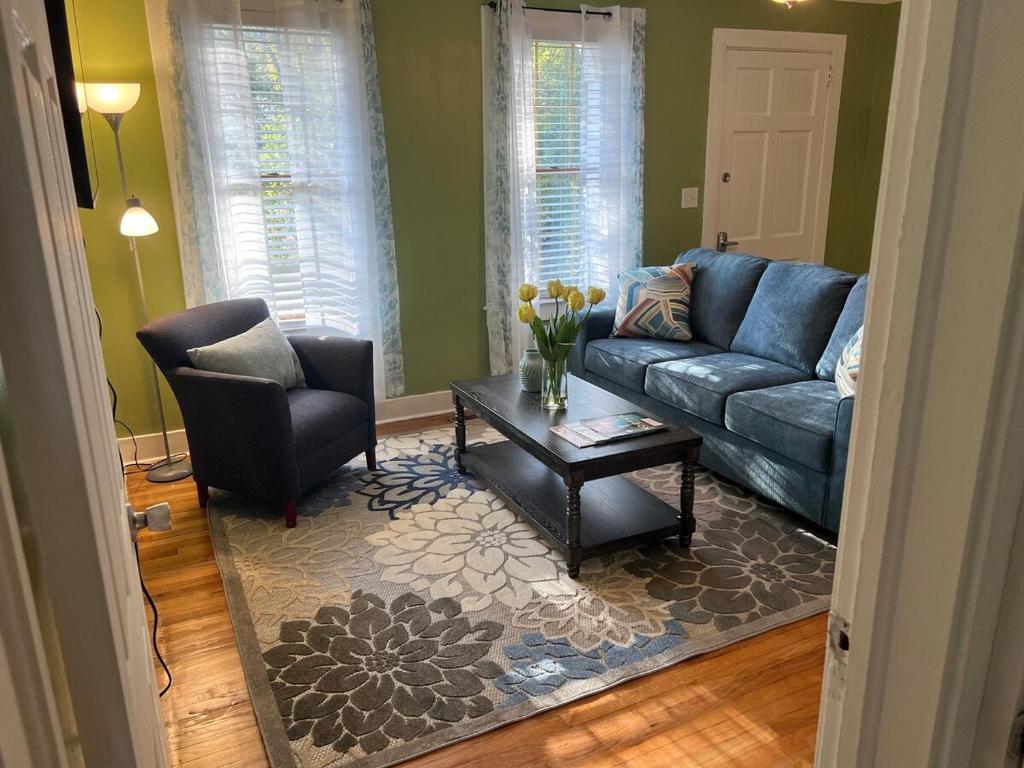 a living room with a blue couch and a chair at Cute 2 bedroom home ! in Augusta