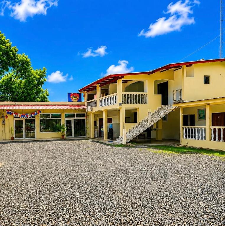 a yellow building with a staircase in front of it at Hotel Comfort Trujillo in La Milagrosa