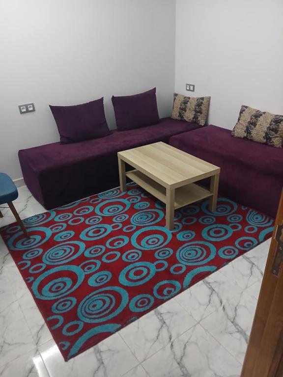 a living room with a couch and a table on a rug at 925 تجزئة الفتح خريبكة 5 in Khouribga