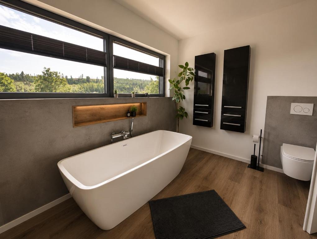 a bathroom with a large white tub and a sink at Bergkultur Sauerland in Medebach