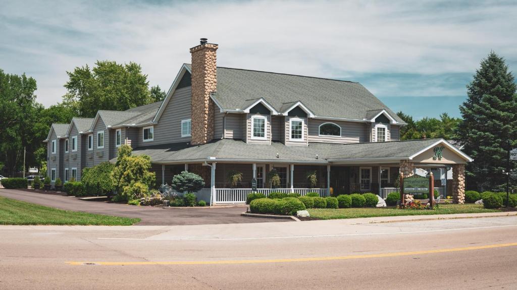 a large house with a gray roof at Hearthstone Inn & Suites in Cedarville