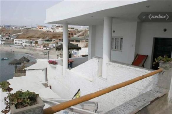 un edificio blanco con algunas plantas en un balcón en Posada del Mirador Italyan Villa, en San Bartolo