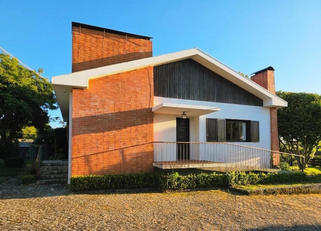 a brick house with a balcony on the side of it at Casa D'Afife in Afife