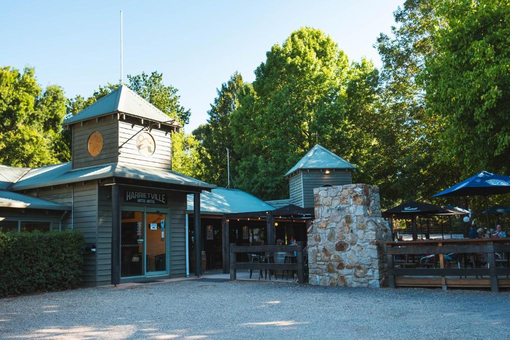 a building with a clock tower on top of it at Harrietville Hotel Motel in Harrietville