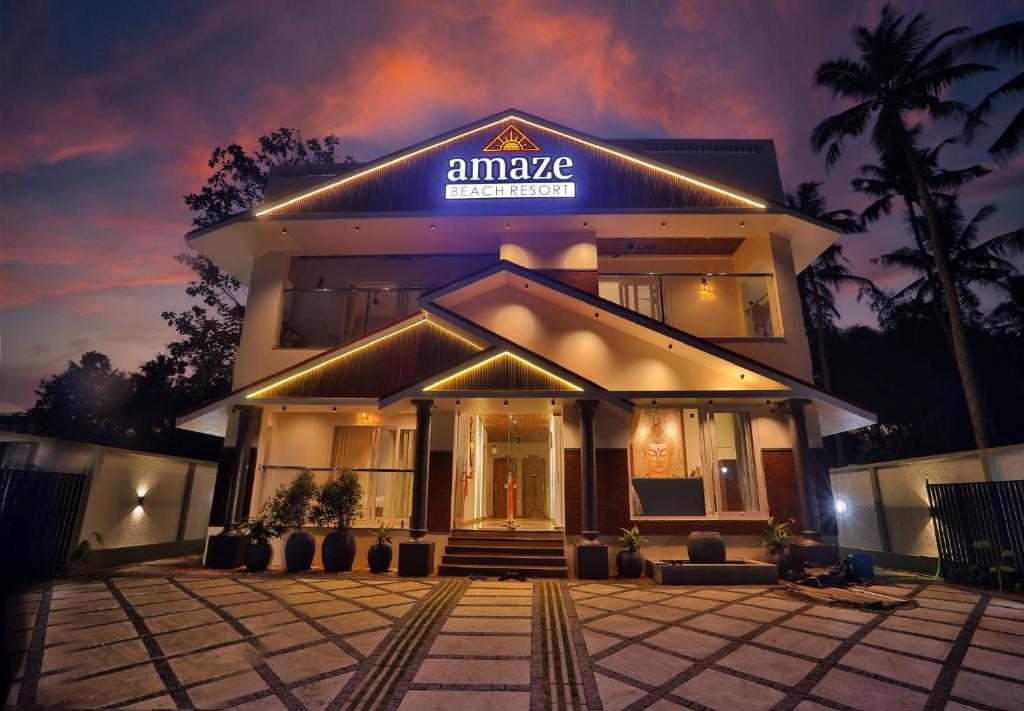 a building with a sign on the front of it at amaze Beach Resort in Varkala