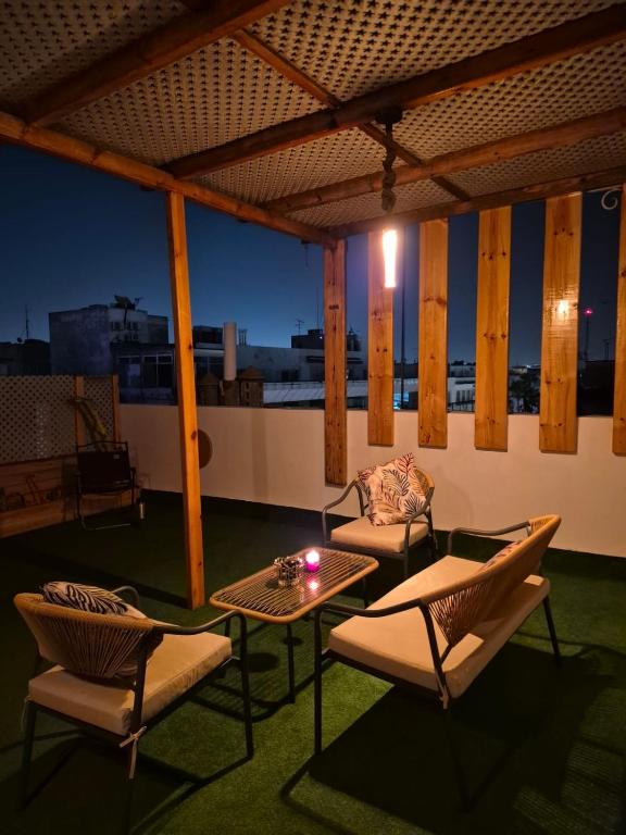 a patio with two chairs and a table and a table at Rabat hassan in Rabat