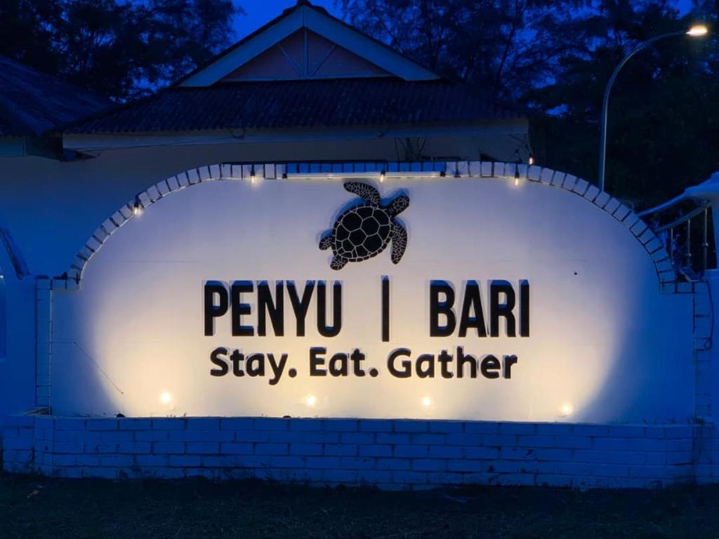 a sign for a turtle sanctuary at night at Penyu Bari in Setiu