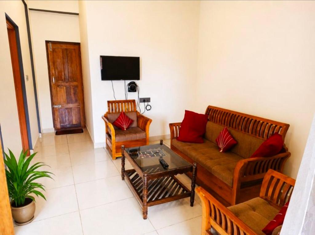 a living room with a couch and a table at The two bedroom house in Madikeri