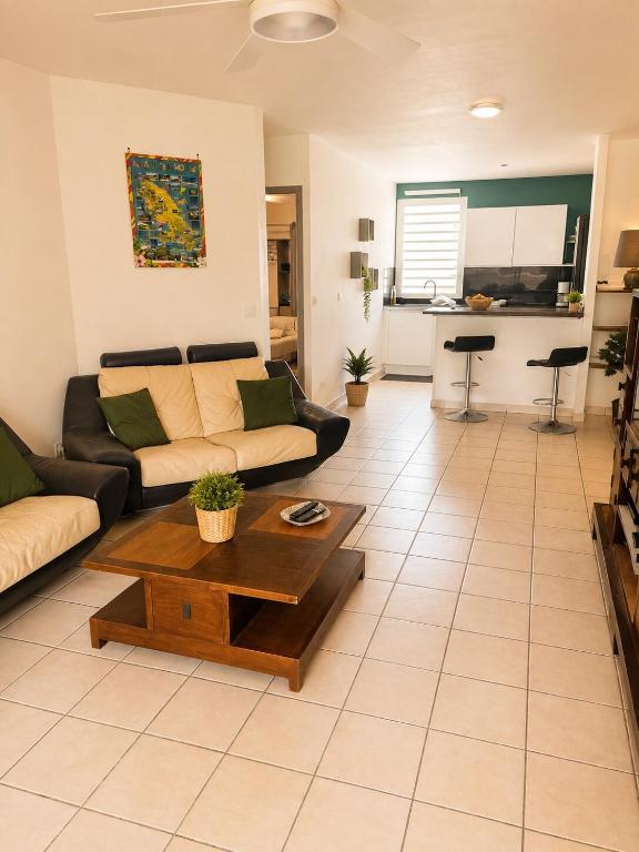a living room with a couch and a coffee table at Le Cocon de Mont-Vert in Le Robert