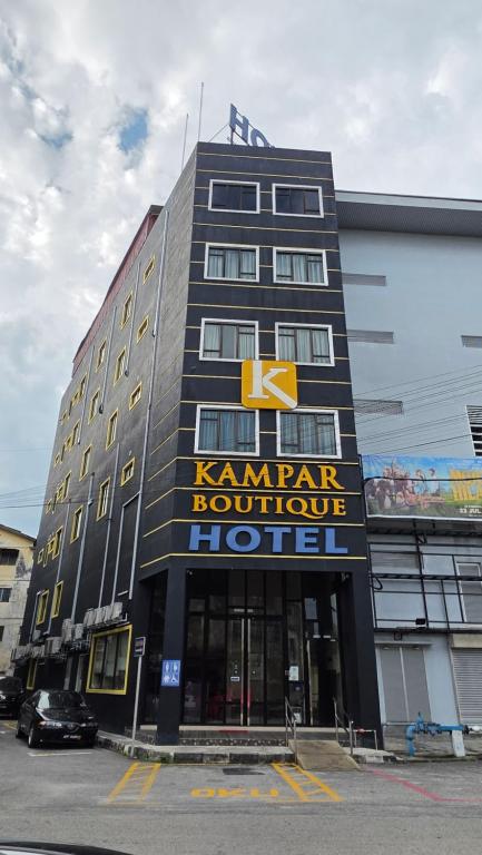 a hotel with a sign on the front of it at Kampar Boutique Hotel in Kampar
