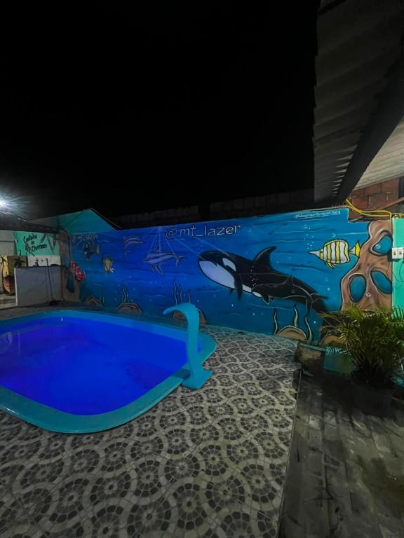 a mural on the side of a water park at night at MT laser in São José da Coroa Grande