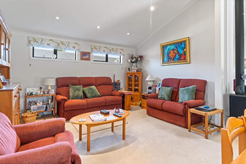 a living room with two couches and a table at Sunset Paradise in Pontud