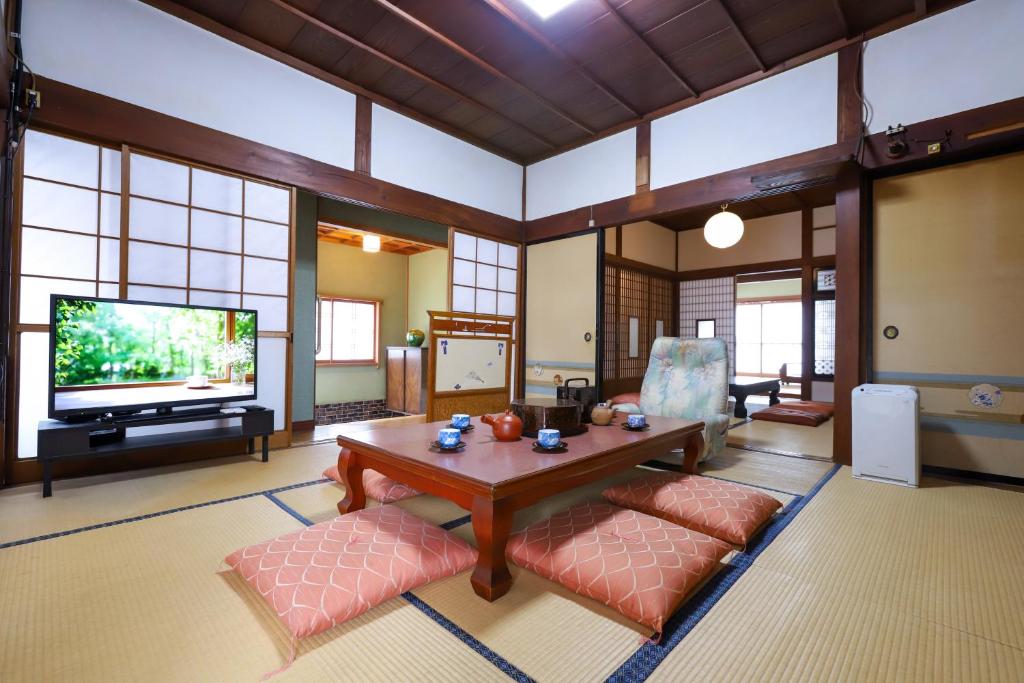 a large living room with a table and a tv at 湊の宿あまね in Hitachinaka