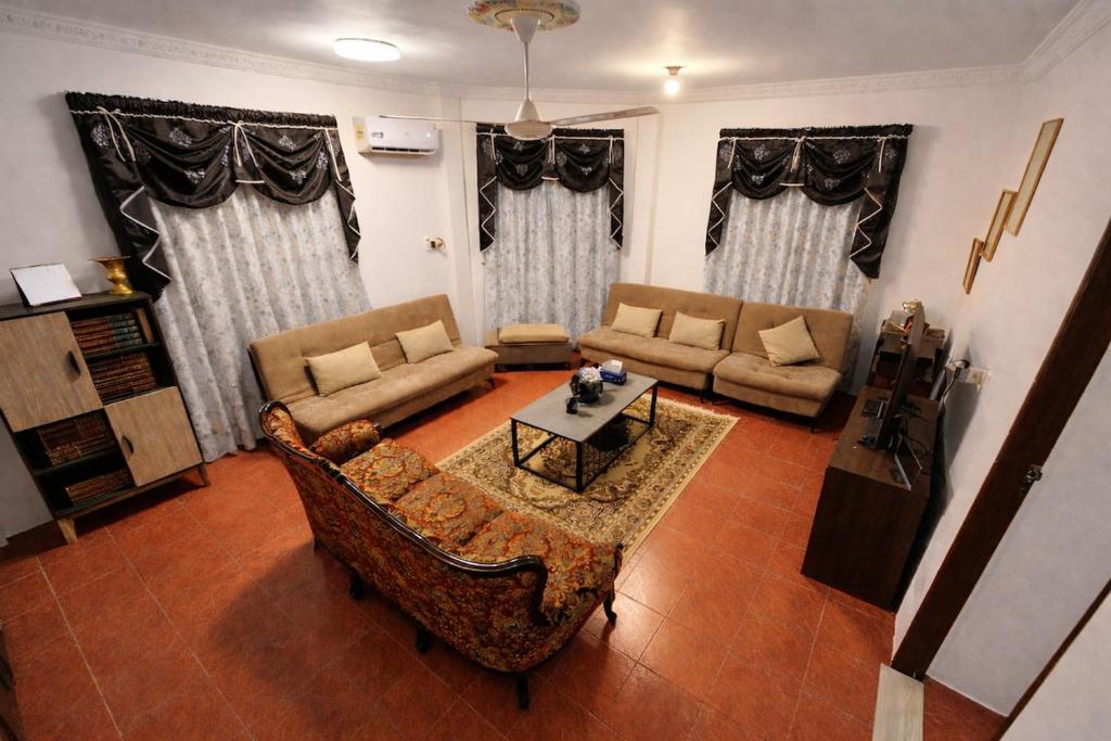 a living room with a couch and a table at Wobbless Wonder Homestay in Bandar Seri Begawan
