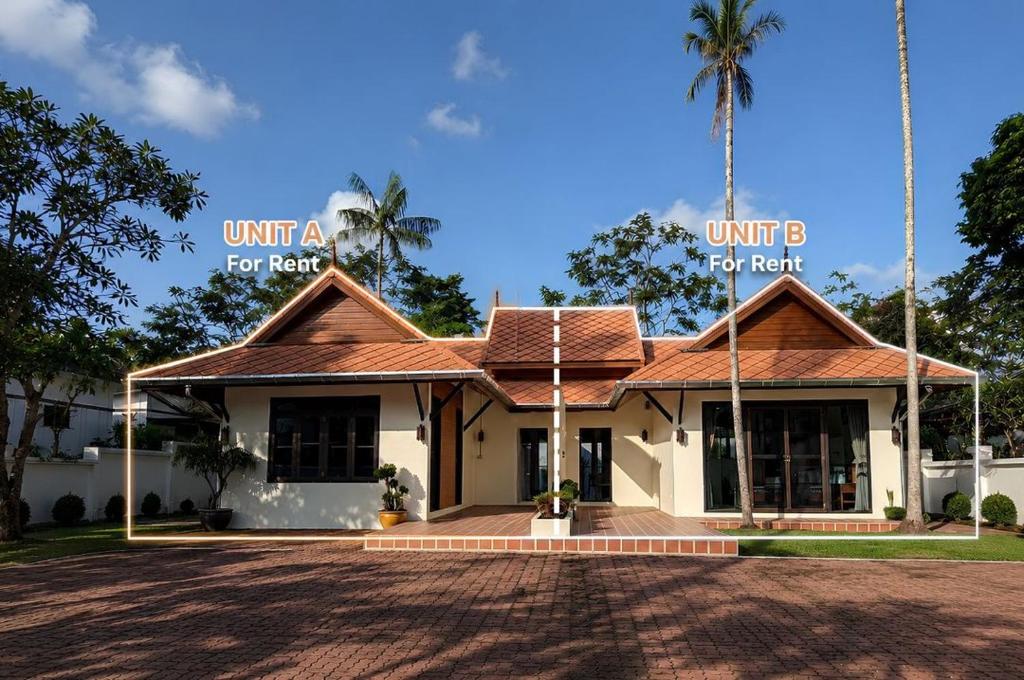 a building with words unit a for rent and a palm tree at Villa Tara Khaolak in Khao Lak
