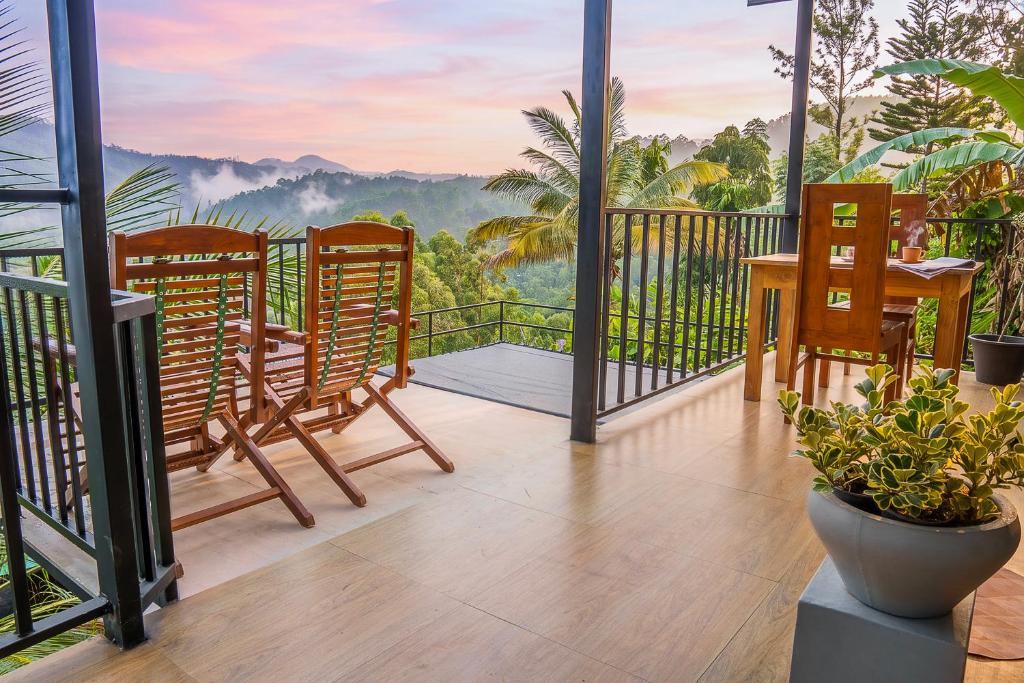 a balcony with chairs and a table and a view at Rock View Cottage in Ella