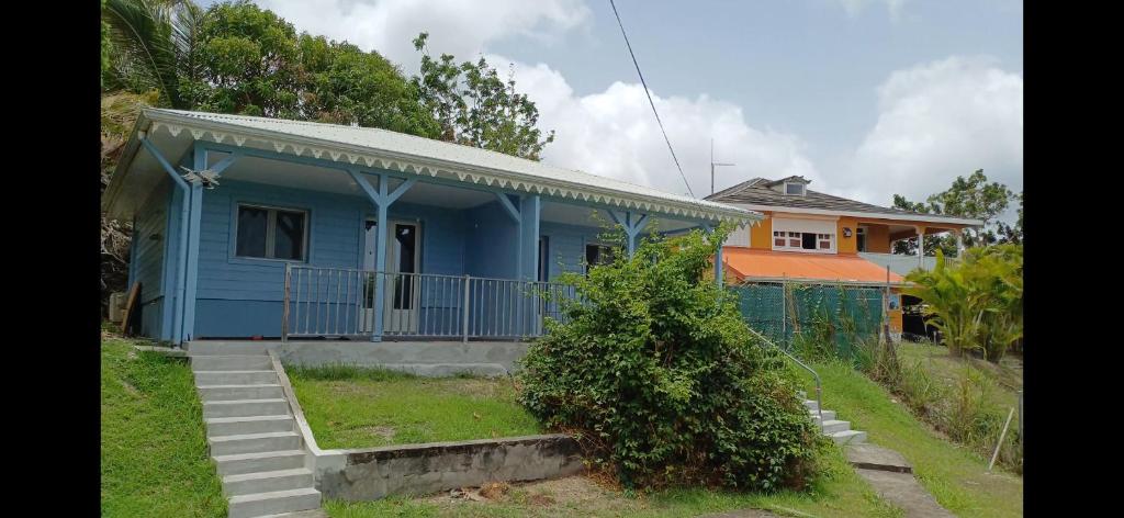 a blue house with a fence in front of it at Blue Dream in Morne Blanc