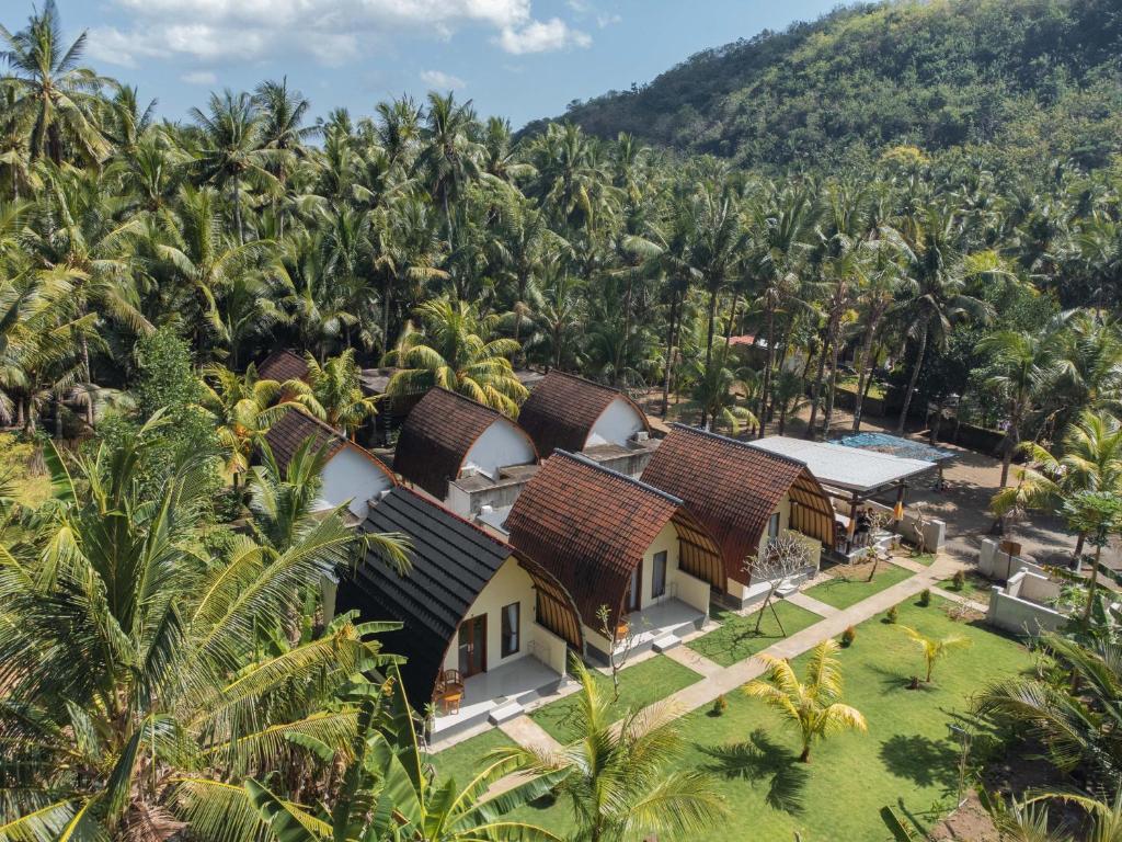 an aerial view of a resort with palm trees at The Kaci Penida By Bali Cabin in Nusa Penida