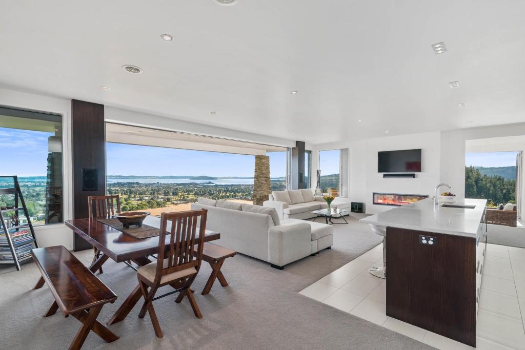 a living room with a couch and a table at Tihi Retreat in Rotorua