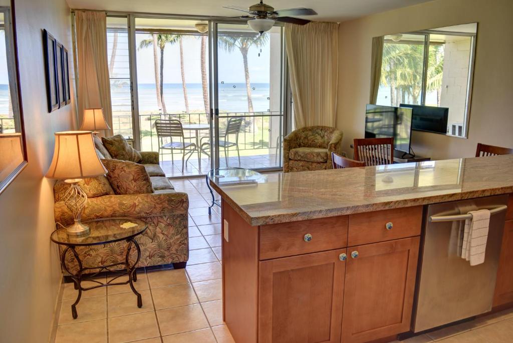 a kitchen and living room with a view of the ocean at Hale Kai O'Kihei 219 in Kihei
