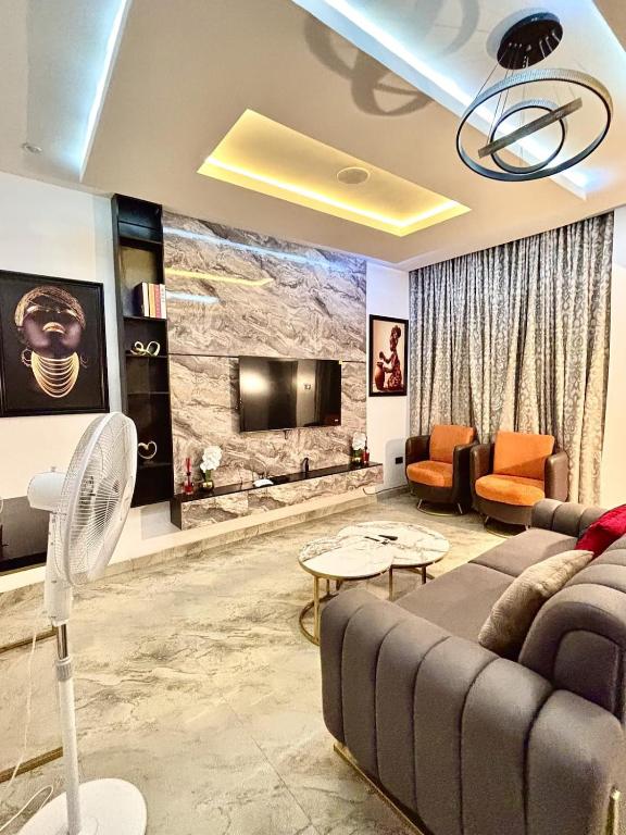 a living room with a couch and a tv at Modern getaway in Ajah in Lekki