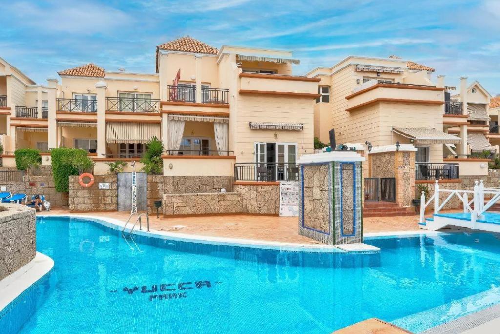 a large swimming pool in front of a building at Benny Fañabé - 2 Bed and Loft Apartment, AC, Pool & Parking in Adeje