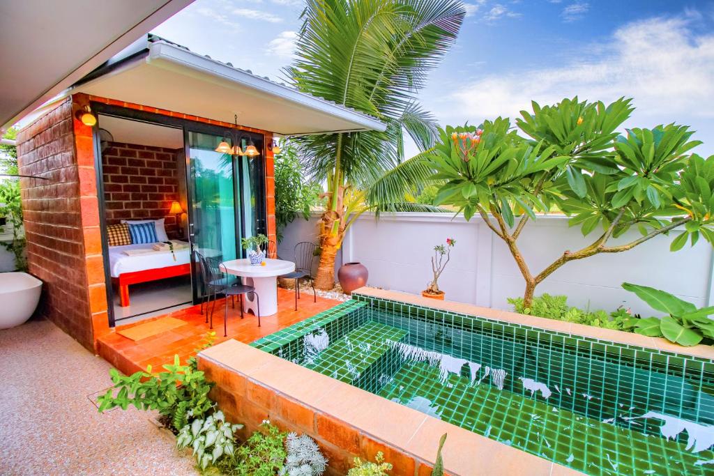 a swimming pool in the backyard of a house at Ped pool villa in Buriram