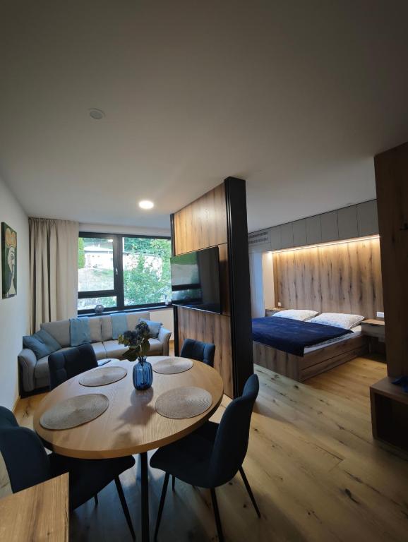 a living room with a table and a couch at Apartmán Vyhne in Vyhne