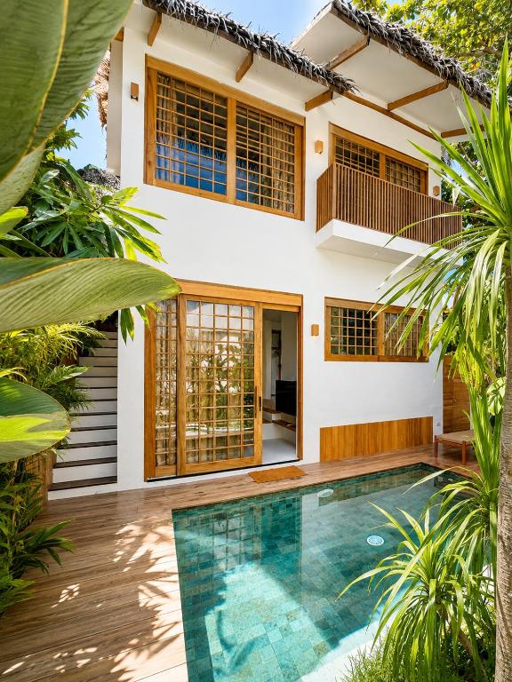 a house with a swimming pool in front of it at Haku - Japandi Village in General Luna