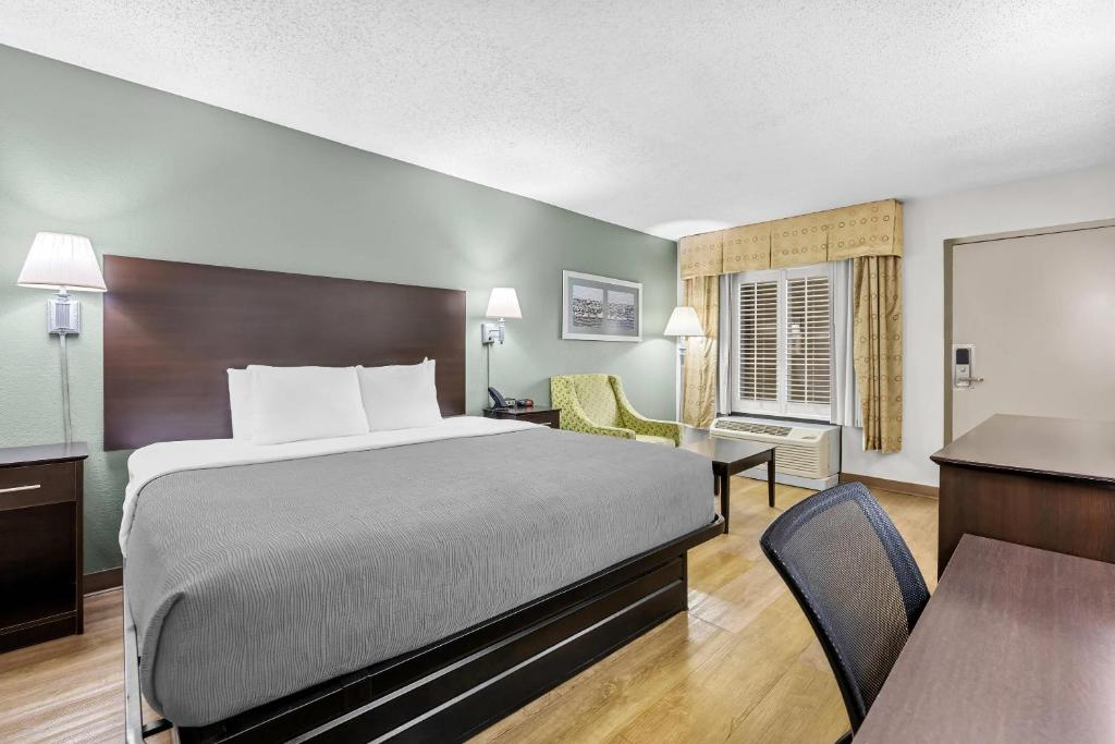 a hotel room with a bed and a desk at Quality Inn Albany in Albany