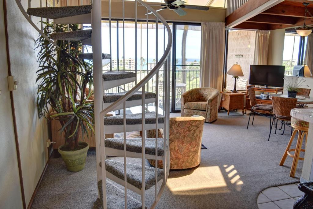 a spiral staircase in a room with a living room at Kihei Alii Kai D402 in Kihei