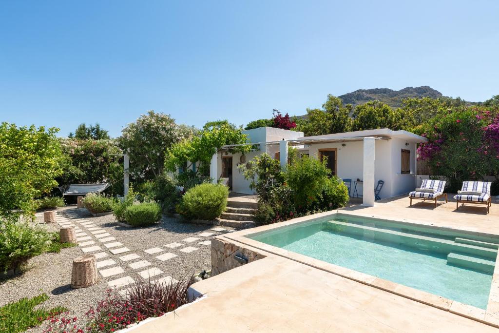 a backyard with a swimming pool and a house at Ktima Natura in Archangelos