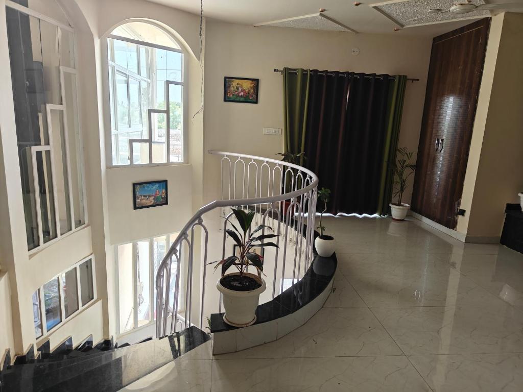a hallway with a spiral staircase with a potted plant at The Heritage villa in Udaipur