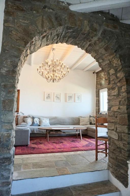 a living room with a couch and a chandelier at Villa Tina in Arnados