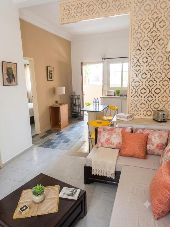 a living room with a couch and a table at house in rafraf beach in Rafrāf