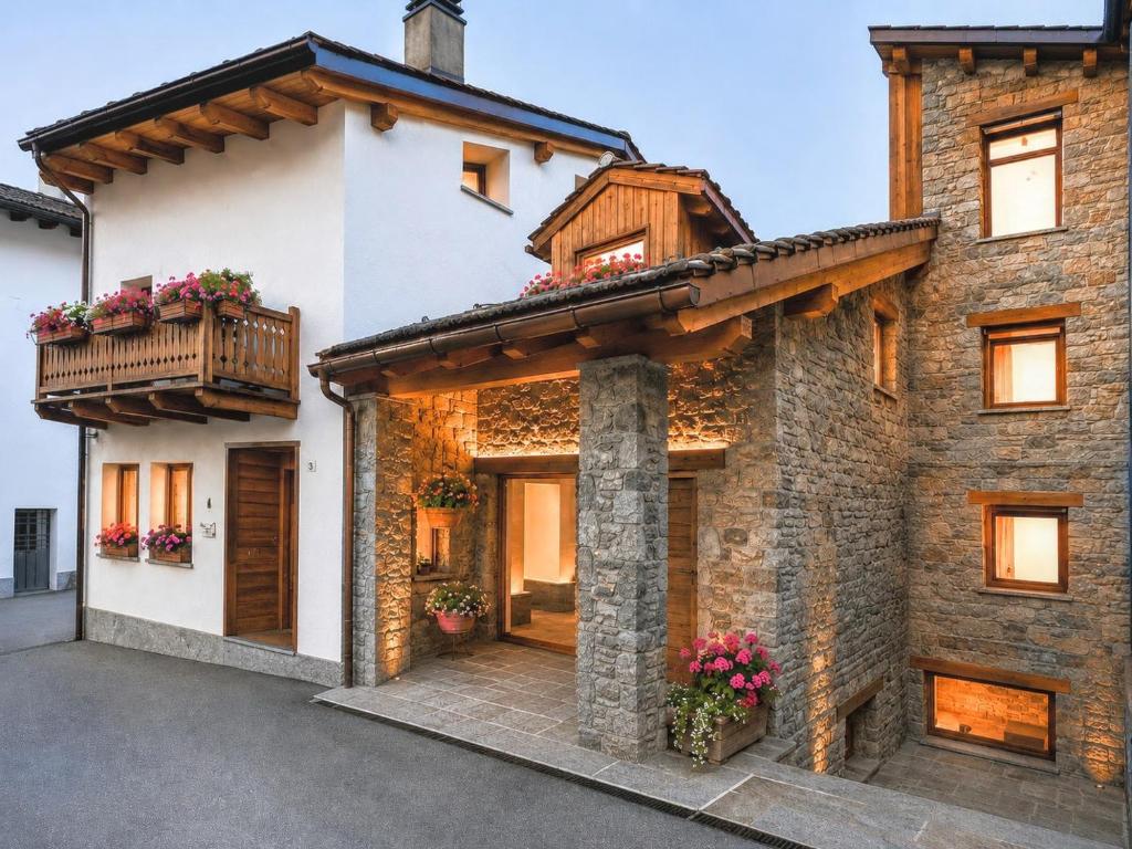a large brick house with a balcony on it at Fenat - Alpine Living in Introd