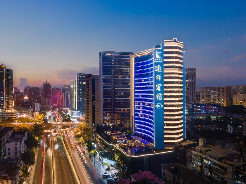 a tall building in a city at night at Ocean Hotel Guangzhou in Guangzhou