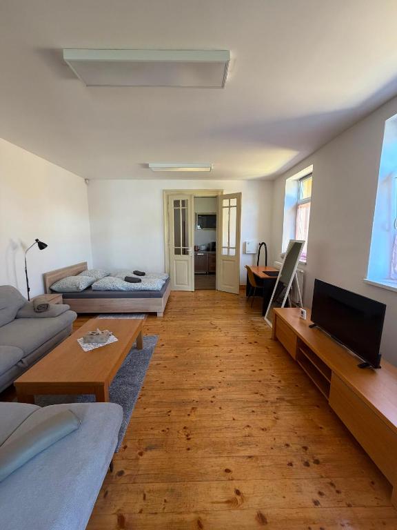 a living room with a couch and a table at Centrum Brezno in Brezno