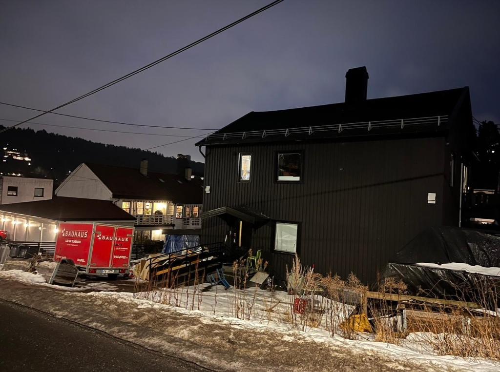 a black house with a red truck in front of it at Asleep in the Valley Villa in Oslo