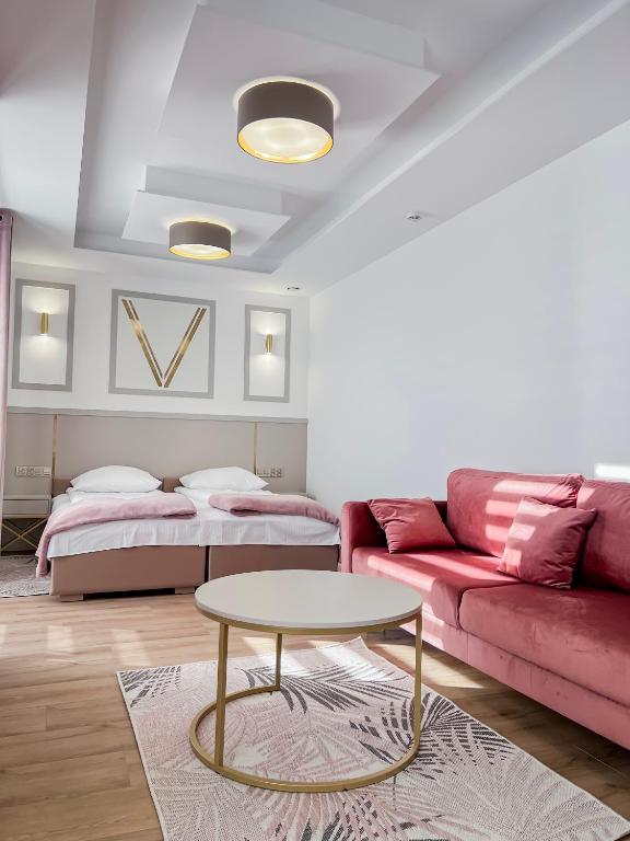 a living room with a couch and a table at VENETIA-Rooms in Biecz