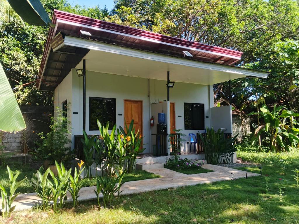 a small house with a porch at LIBYA's Guesthouse in San Juan