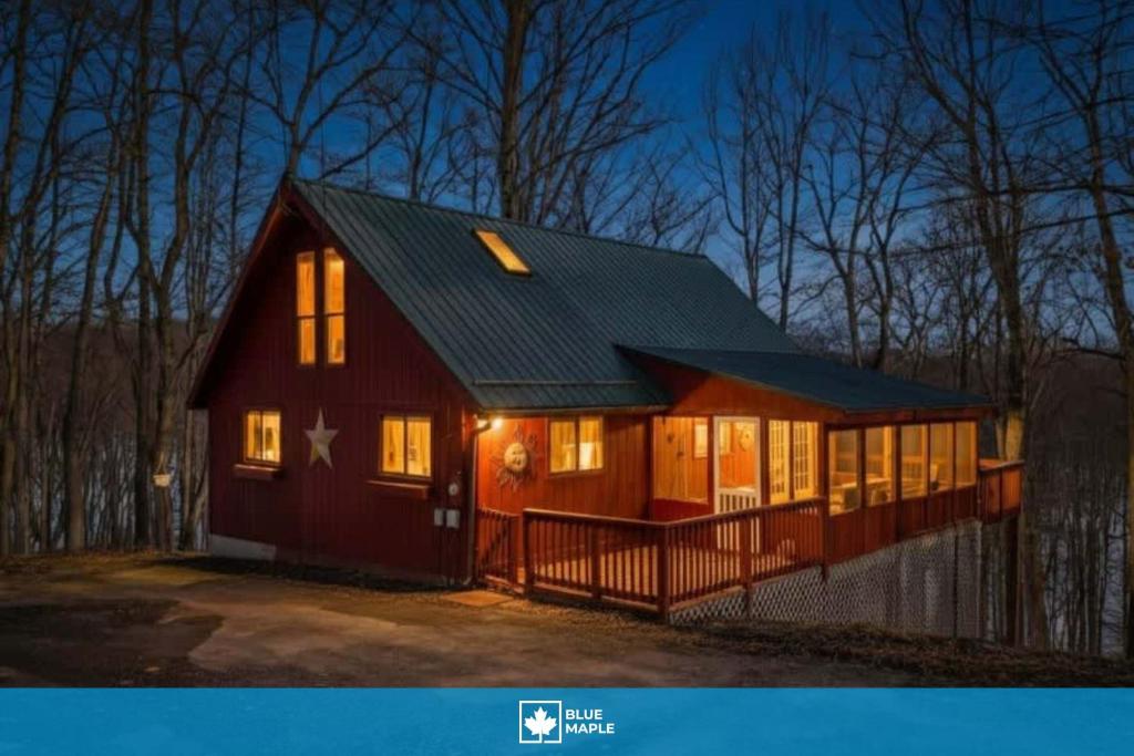 a red barn with lights on in the night at Pet-Friendly w Fire Pit Grill & Resort Access in Hedgesville