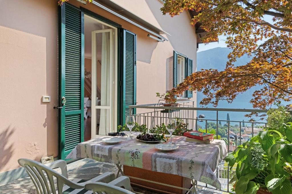 a table and chairs on a balcony with a view at Bellagio House Antico Ulivo in Bellagio