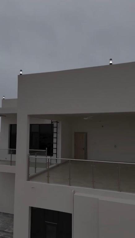 a large white building with a balcony on top of it at دوحة ظُفار للعقارات in Sumhuran