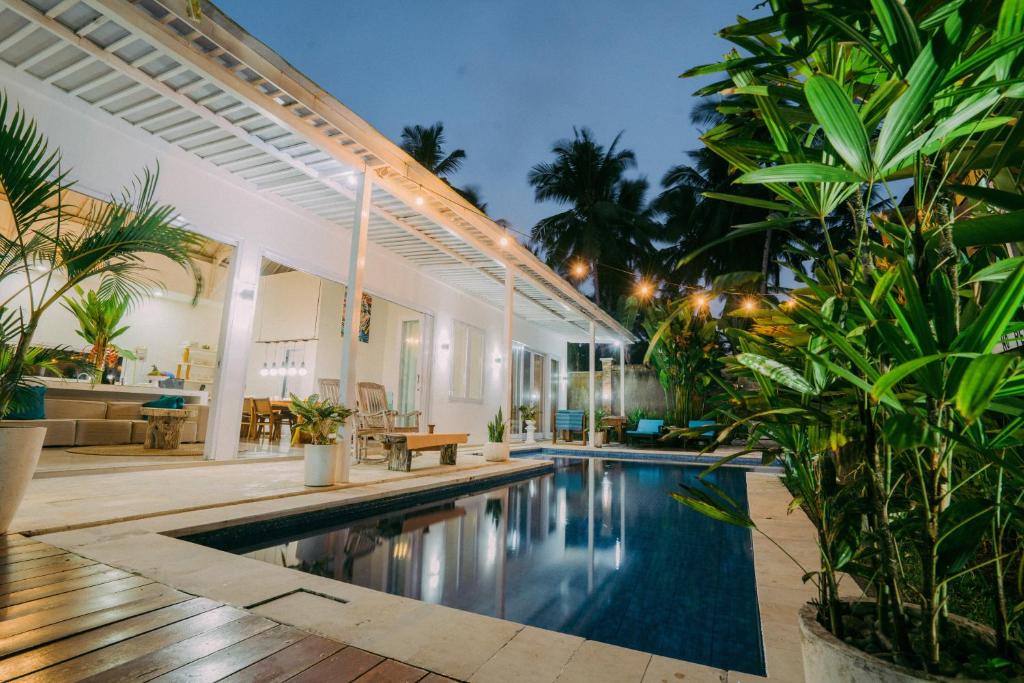 a swimming pool in the middle of a house at Luxury 3-Bedroom Villa with Private Pool in Pulukan